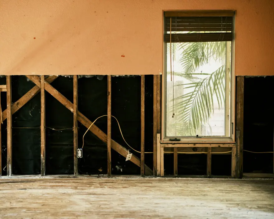 Flood-cut block wall and bare slab after hurricane storm surge in a Punta Gorda, FL house